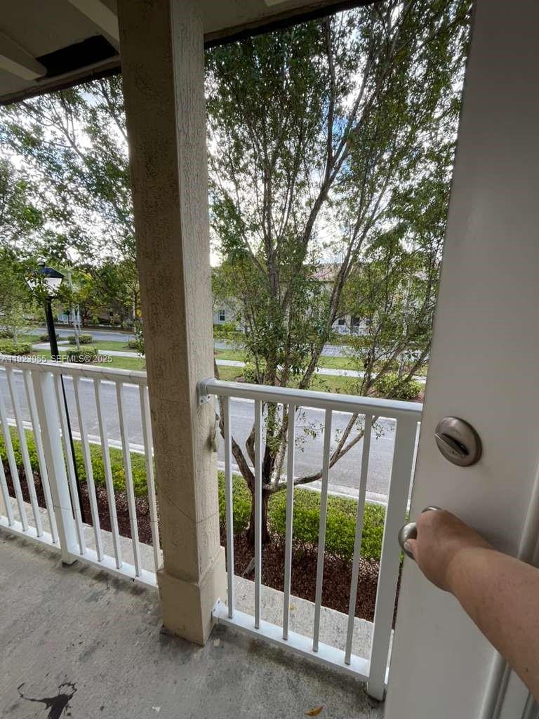 11665 Southwest 244 Street, Unit 116 Homestead, FL 33032 - Photo 15 of 32 a view of a glass door and deck