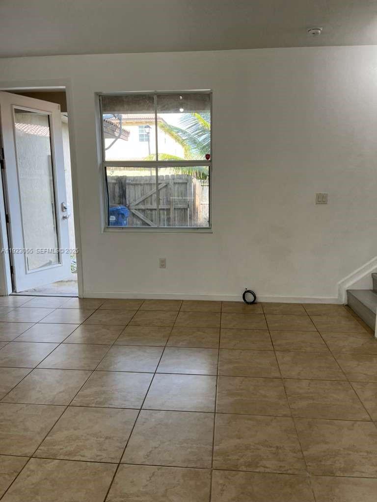 11665 Southwest 244 Street, Unit 116 Homestead, FL 33032 - Photo 2 of 32 a view of an empty room with a window