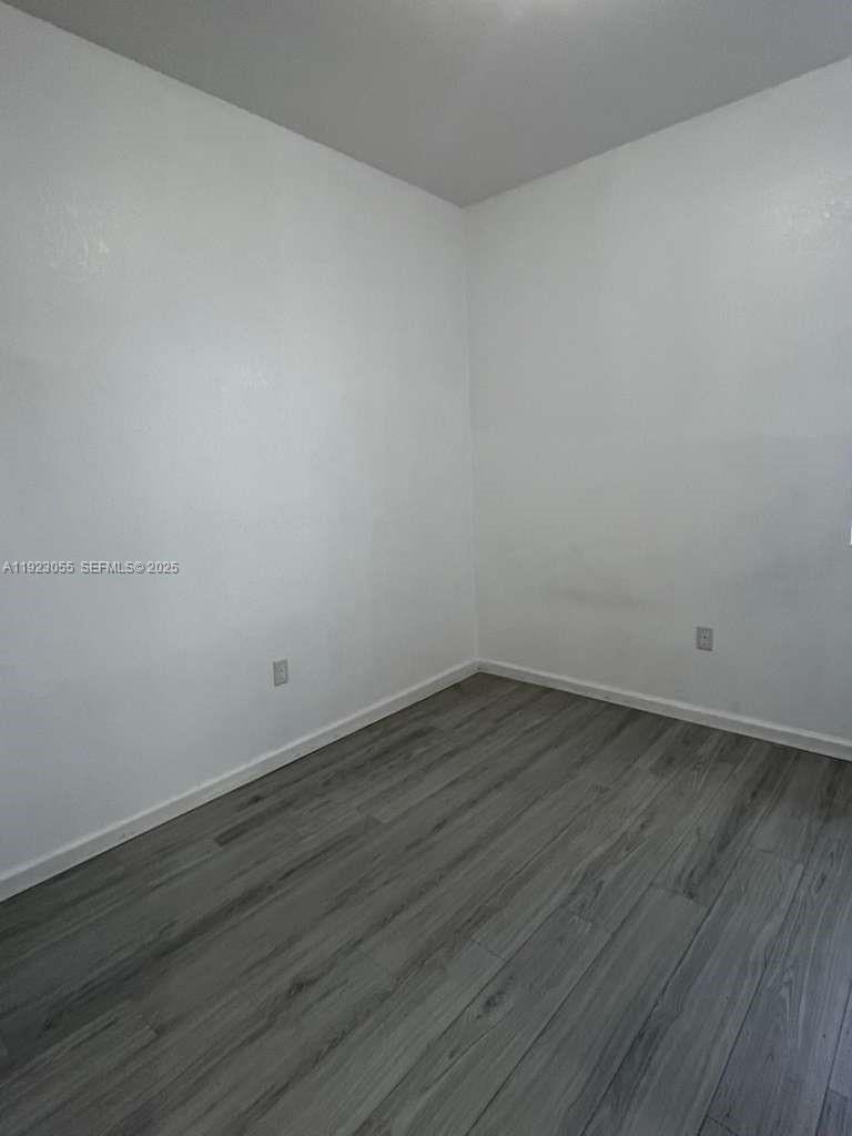 11665 Southwest 244 Street, Unit 116 Homestead, FL 33032 - Photo 24 of 32 a view of an empty room with wooden floor