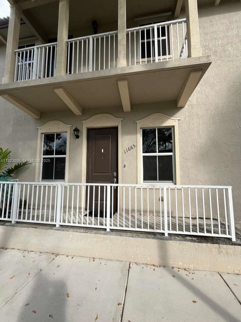 11665 Southwest 244 Street, Unit 116 Homestead, FL 33032 - Photo 3 of 32 a view of a house with a deck