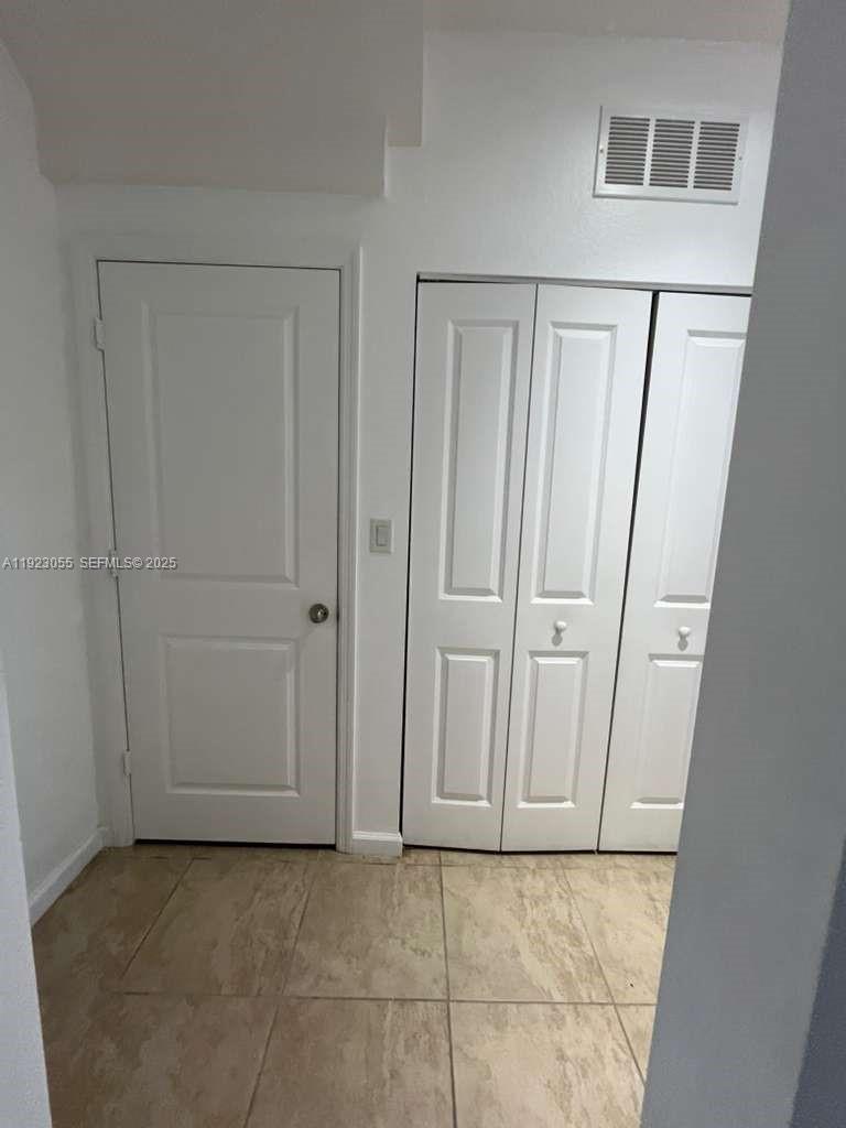 11665 Southwest 244 Street, Unit 116 Homestead, FL 33032 - Photo 8 of 32 a view of a garage