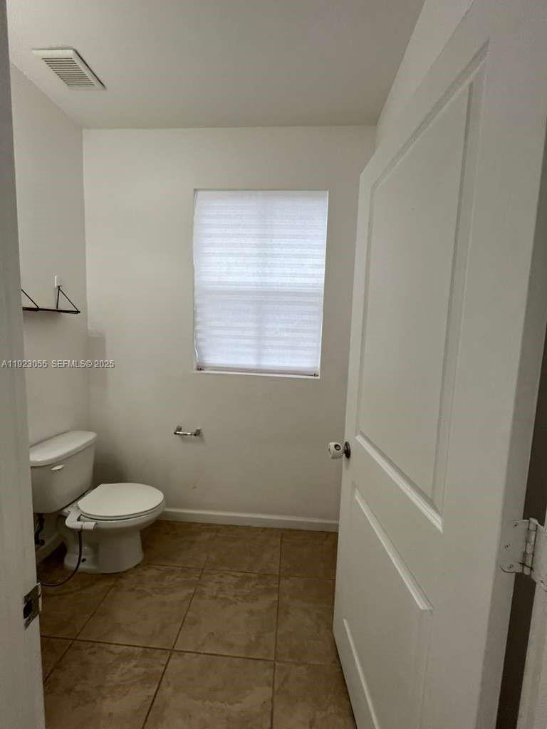 11665 Southwest 244 Street, Unit 116 Homestead, FL 33032 - Photo 9 of 32 a bathroom with a toilet