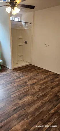 a view of empty room with wooden floor