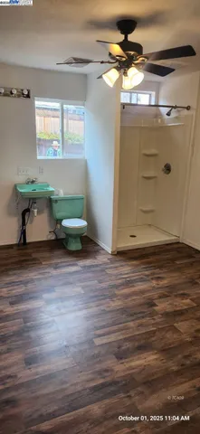 a room with wooden floor and white walls