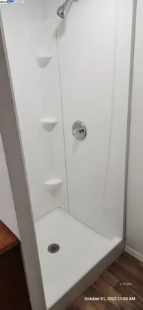 a view of an empty room with kitchen