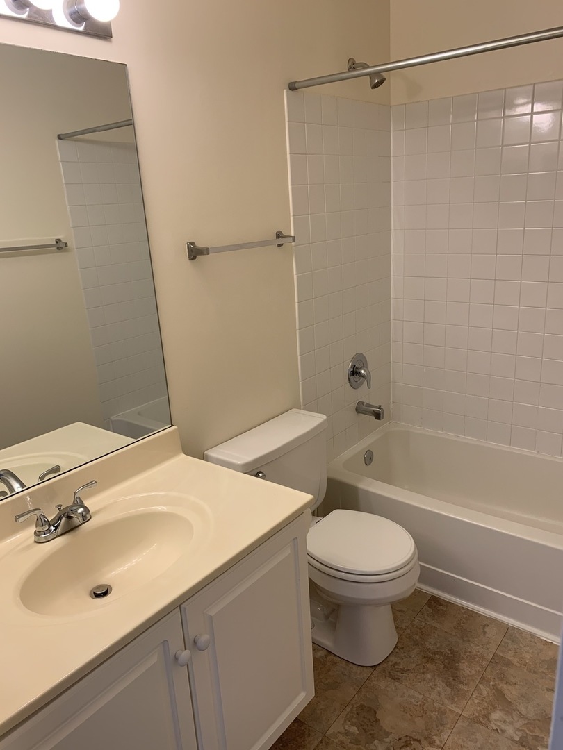 17888 Braewick Road Gurnee, IL 60031 - Photo 3 of 16 a bathroom with a sink a toilet and shower