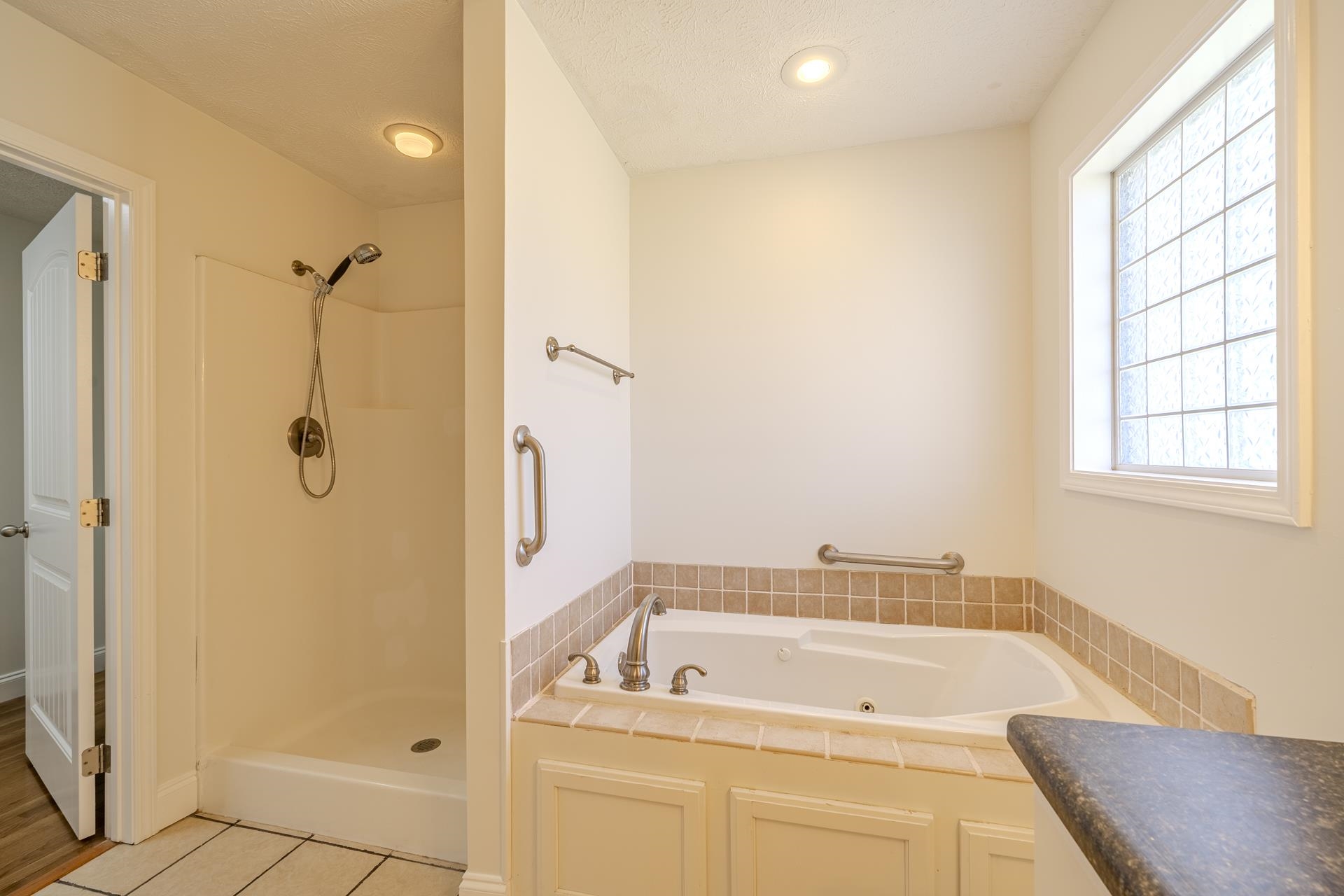 200 Boyd Road Adamsville, TN 38310 - Photo 11 of 26 a bathroom with a tub a sink and a window