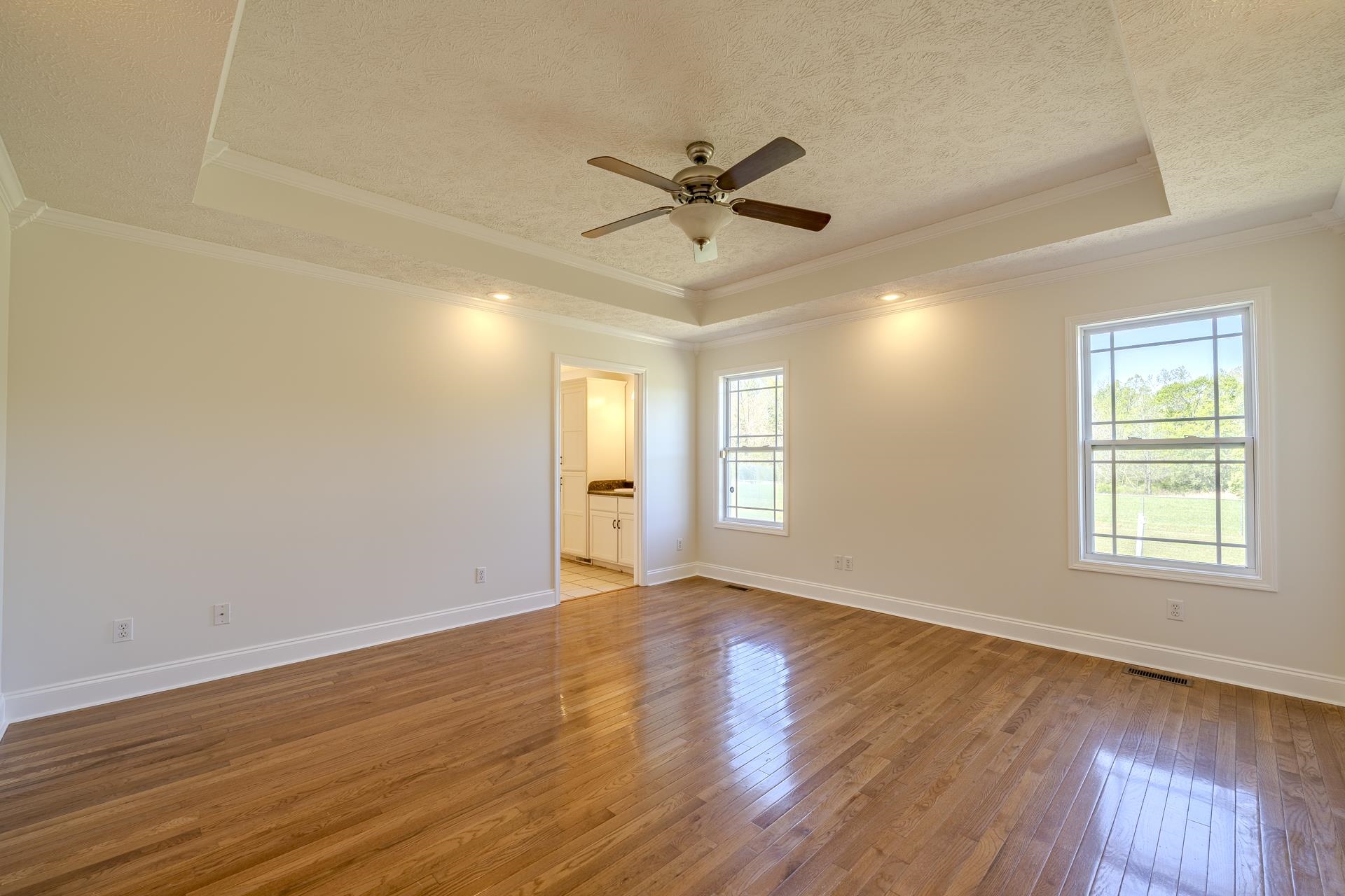 200 Boyd Road Adamsville, TN 38310 - Photo 3 of 26 a view of empty room with wooden floor and fan