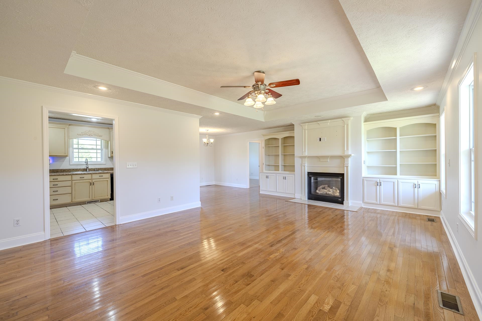 200 Boyd Road Adamsville, TN 38310 - Photo 4 of 26 an empty room with wooden floor and fireplace