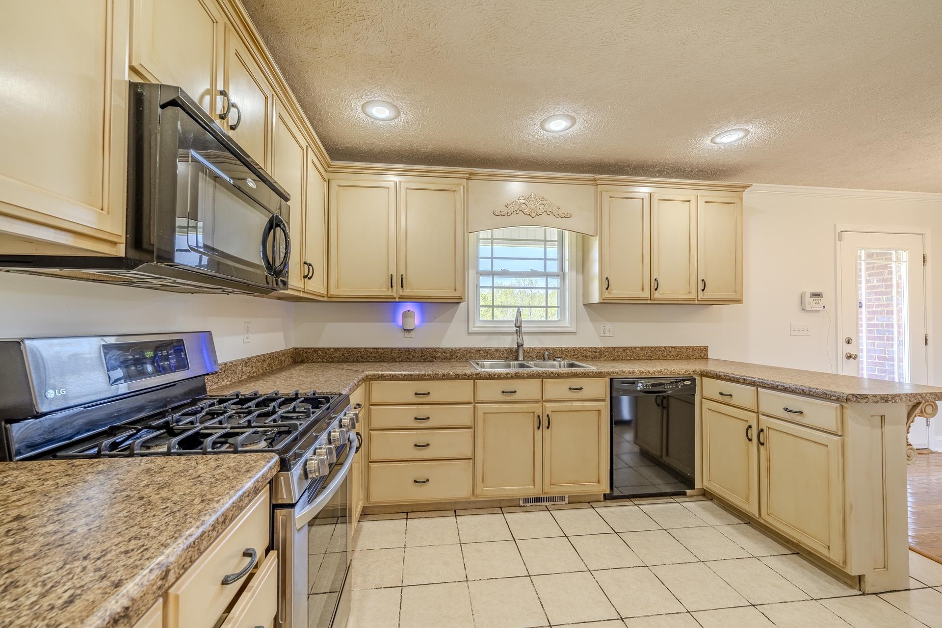 200 Boyd Road Adamsville, TN 38310 - Photo 7 of 26 a kitchen with cabinets appliances a sink and a counter top space