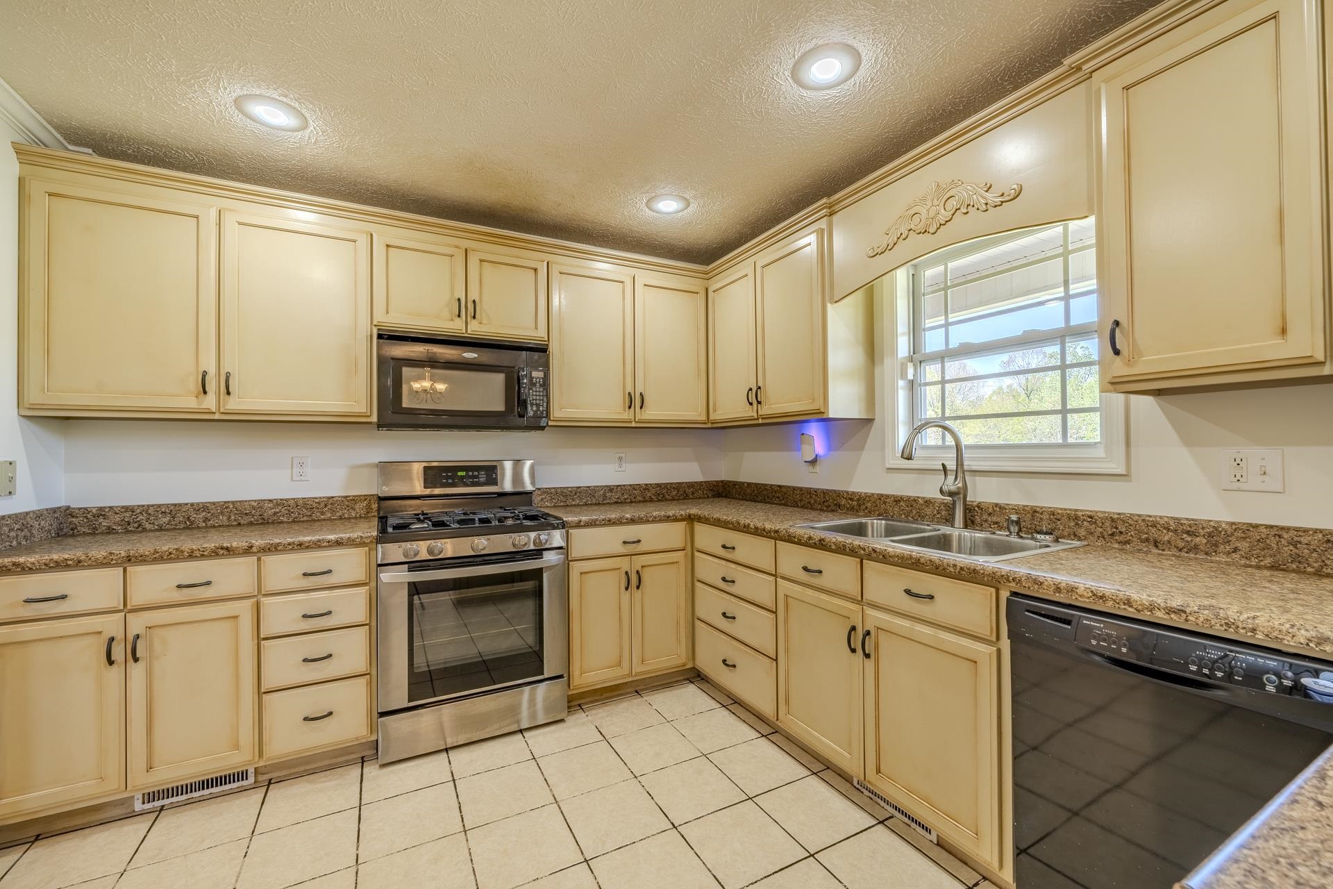 200 Boyd Road Adamsville, TN 38310 - Photo 8 of 26 a kitchen with white cabinets appliances and a sink