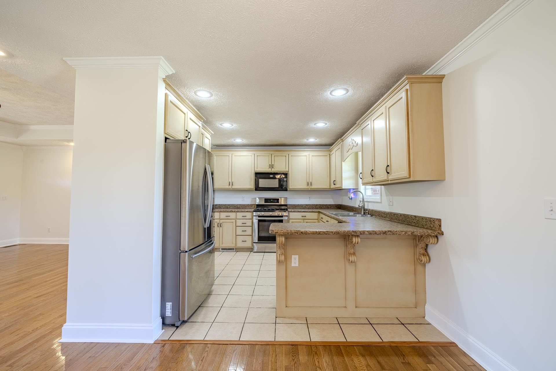 200 Boyd Road Adamsville, TN 38310 - Photo 9 of 26 a kitchen with stainless steel appliances granite countertop a stove a sink and a refrigerator