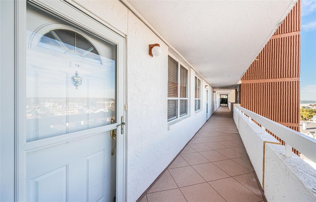 17940 Gulf Boulevard, Unit 7B Redington Shores, FL 33708 - Photo 14 of 58 a view of a hallway with wooden floor and staircase