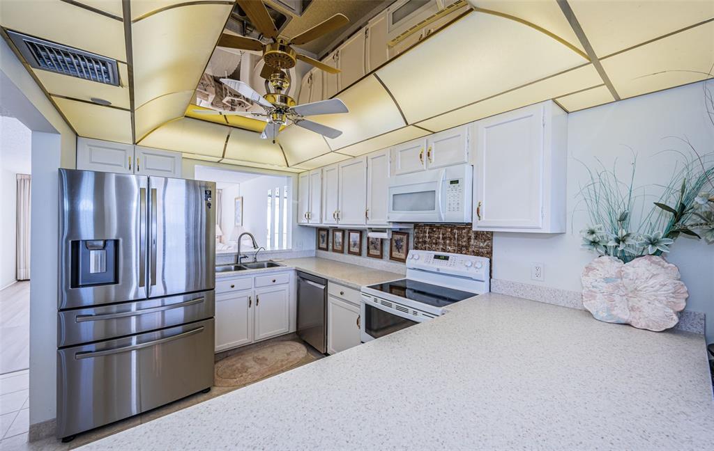 17940 Gulf Boulevard, Unit 7B Redington Shores, FL 33708 - Photo 28 of 58 a kitchen with cabinets and stainless steel appliances