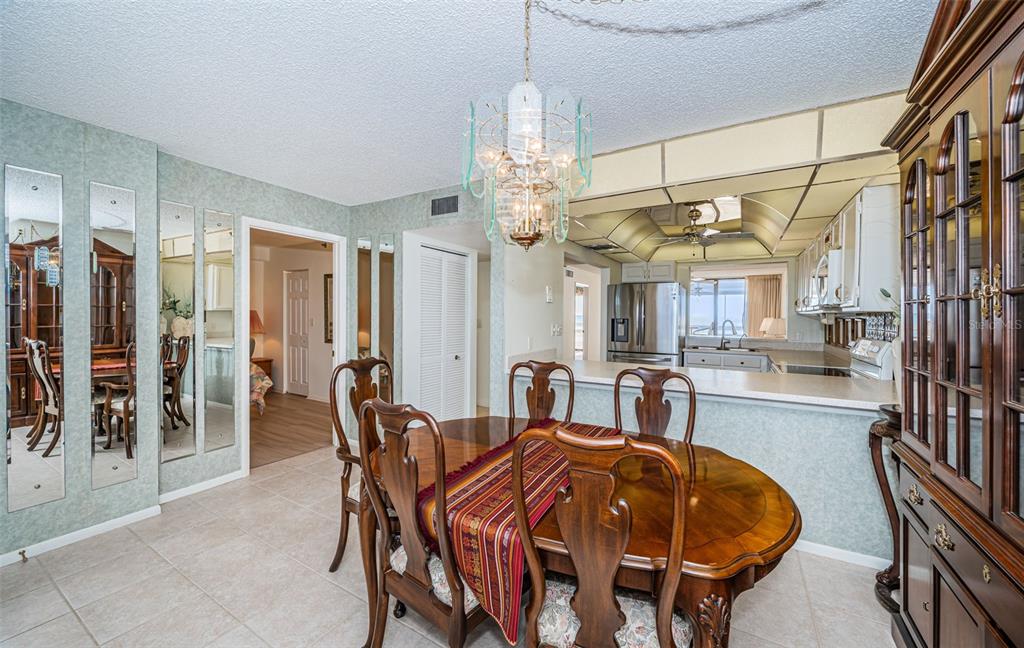 17940 Gulf Boulevard, Unit 7B Redington Shores, FL 33708 - Photo 32 of 58 a dining room with furniture a chandelier and window