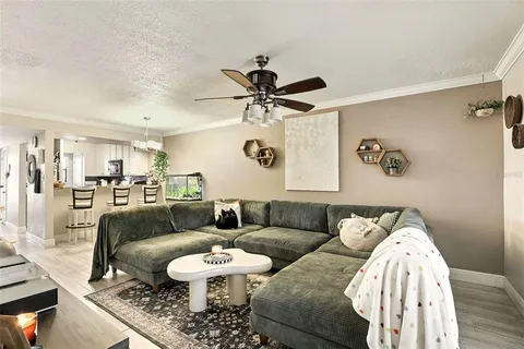a living room with furniture and a chandelier
