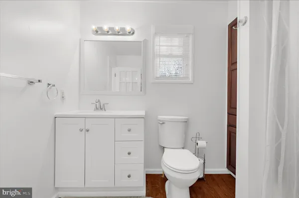 a view of a wooden house with a yard and large tree