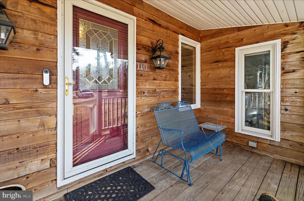 a living room with furniture a flat screen tv and a large window