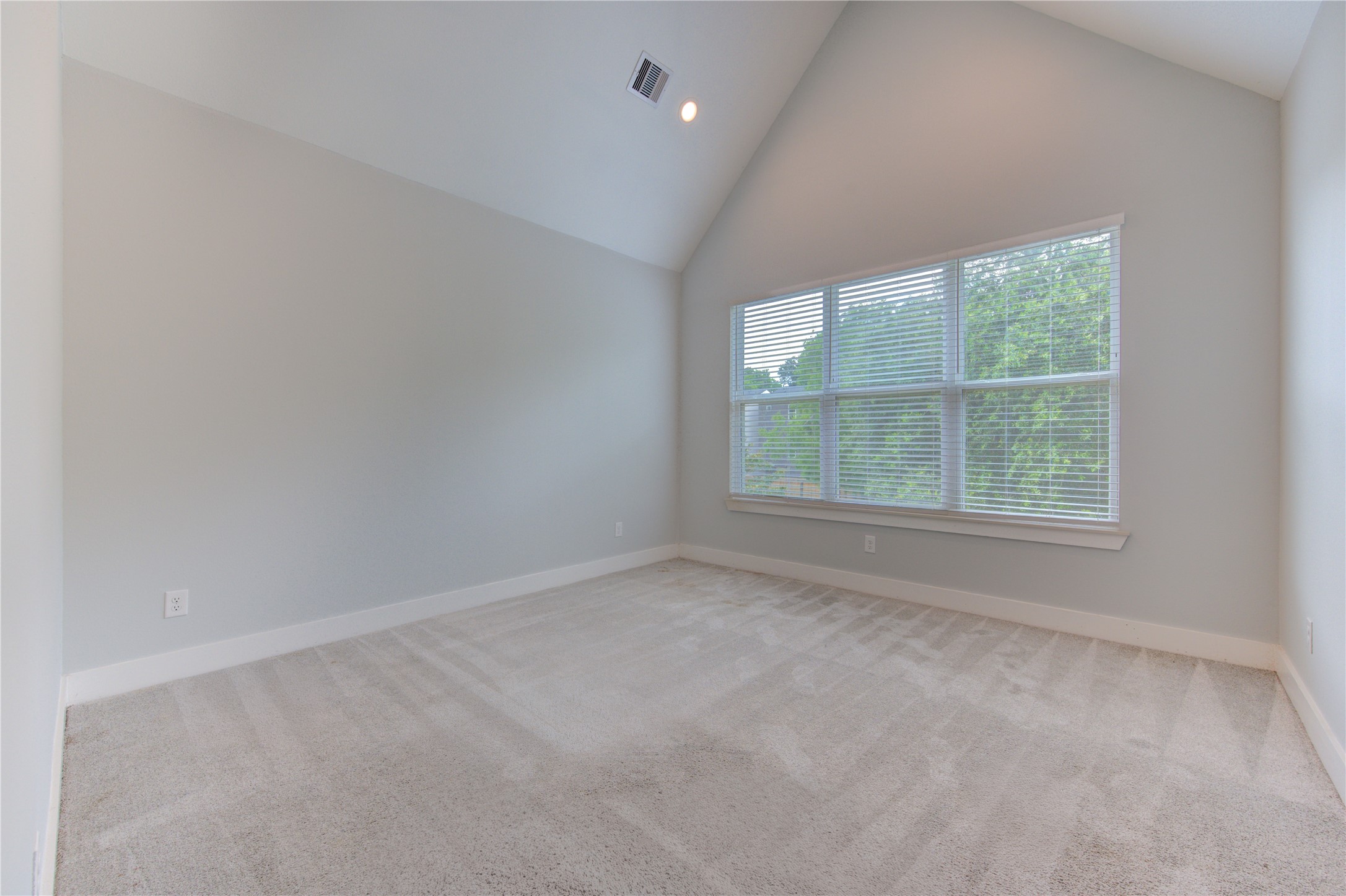 847 Rachel Street, Unit G Houston, TX 77091 - Photo 8 of 42 The primary bedroom features a separate bathroom area and a walk-in closet. Architectural ceiling design enhances the sense of space, complemented by abundant natural light from multiple windows and a walk-in shower.