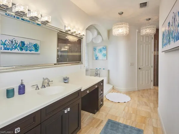 a spacious bathroom with a sink a toilet and a mirror