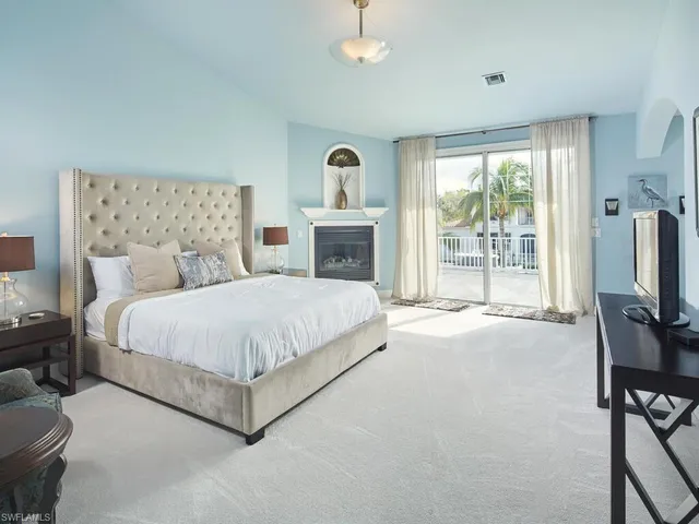 a bed room with a bed and a television