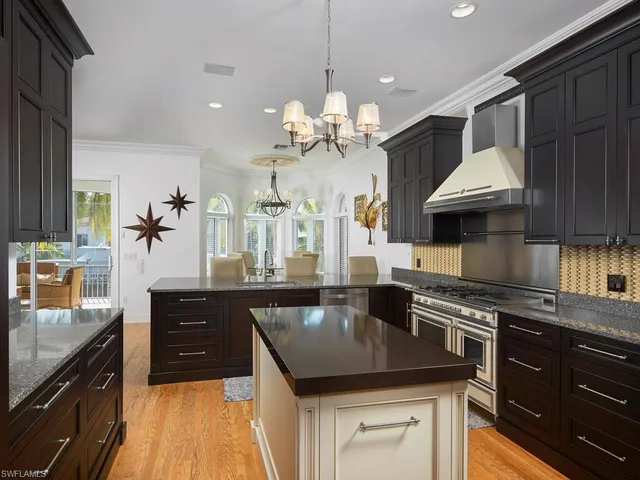 a kitchen with a counter space a sink and cabinets