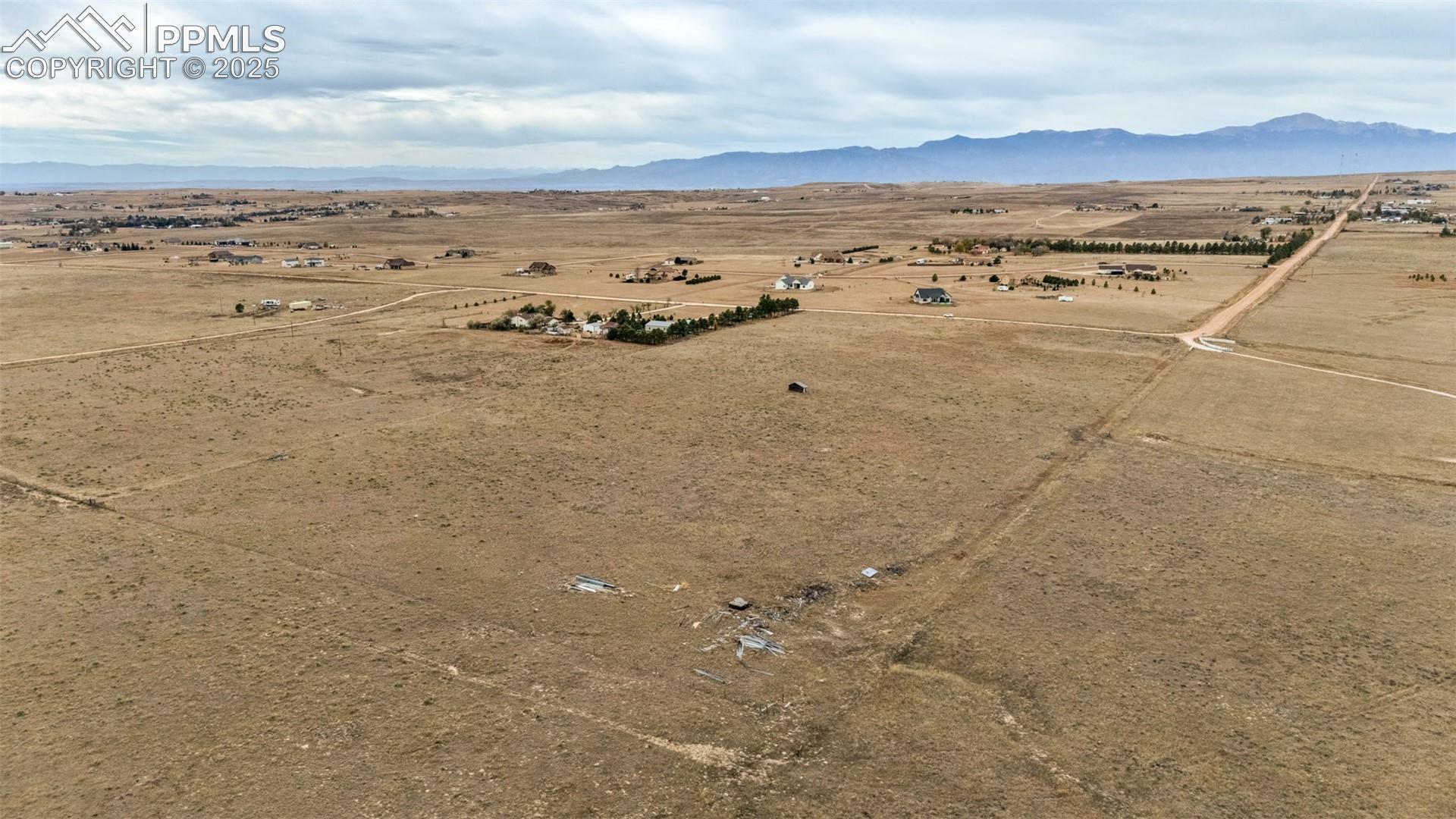 Kennedy Road Peyton, CO 80831 - Photo 1 of 7 Aerial view of sparsely populated area with mountains and a desert landscape