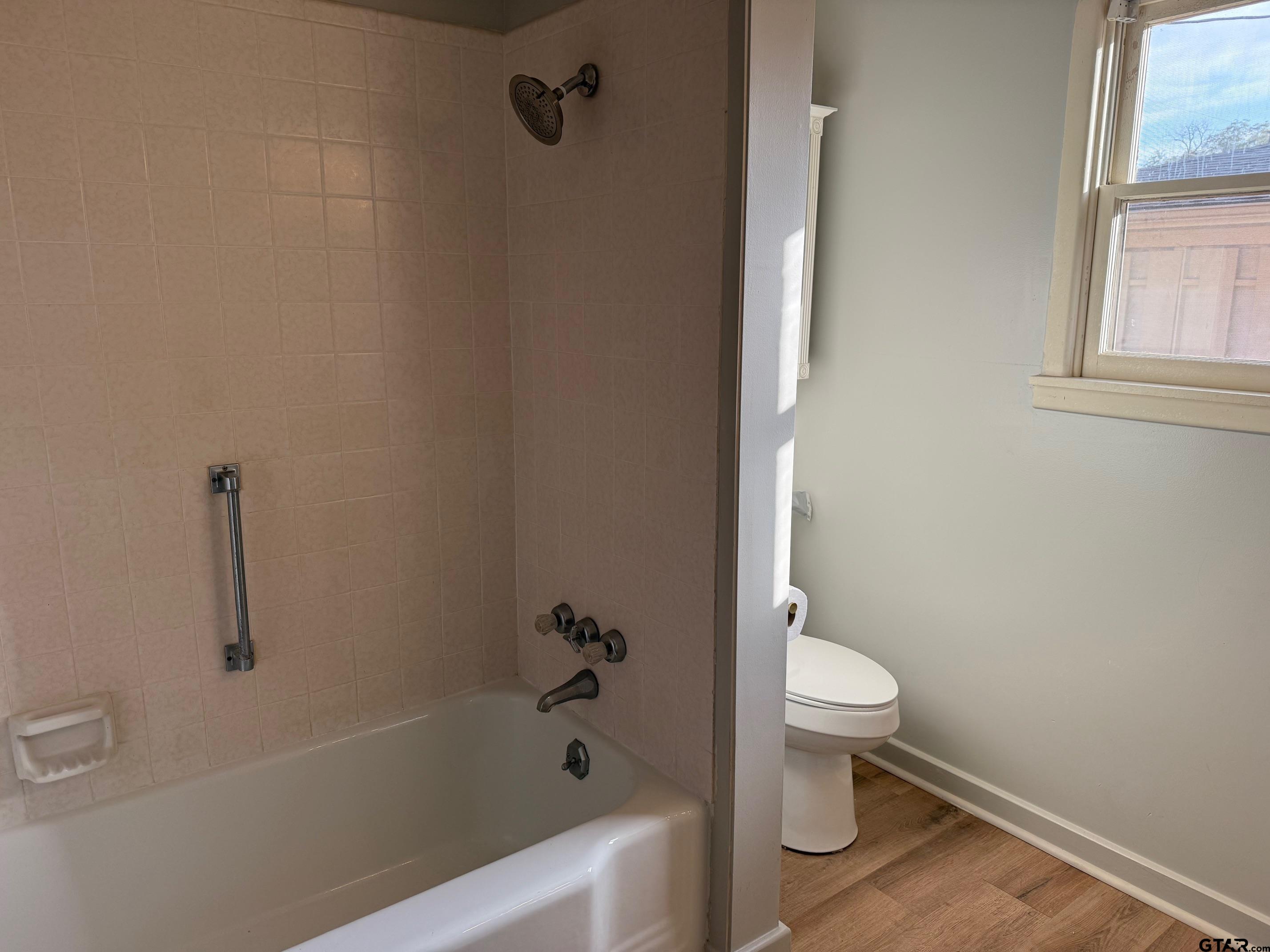 301 Ridgecrest Drive Tyler, TX 75701 - Photo 14 of 27 a bath room with a toilet and a bath tub