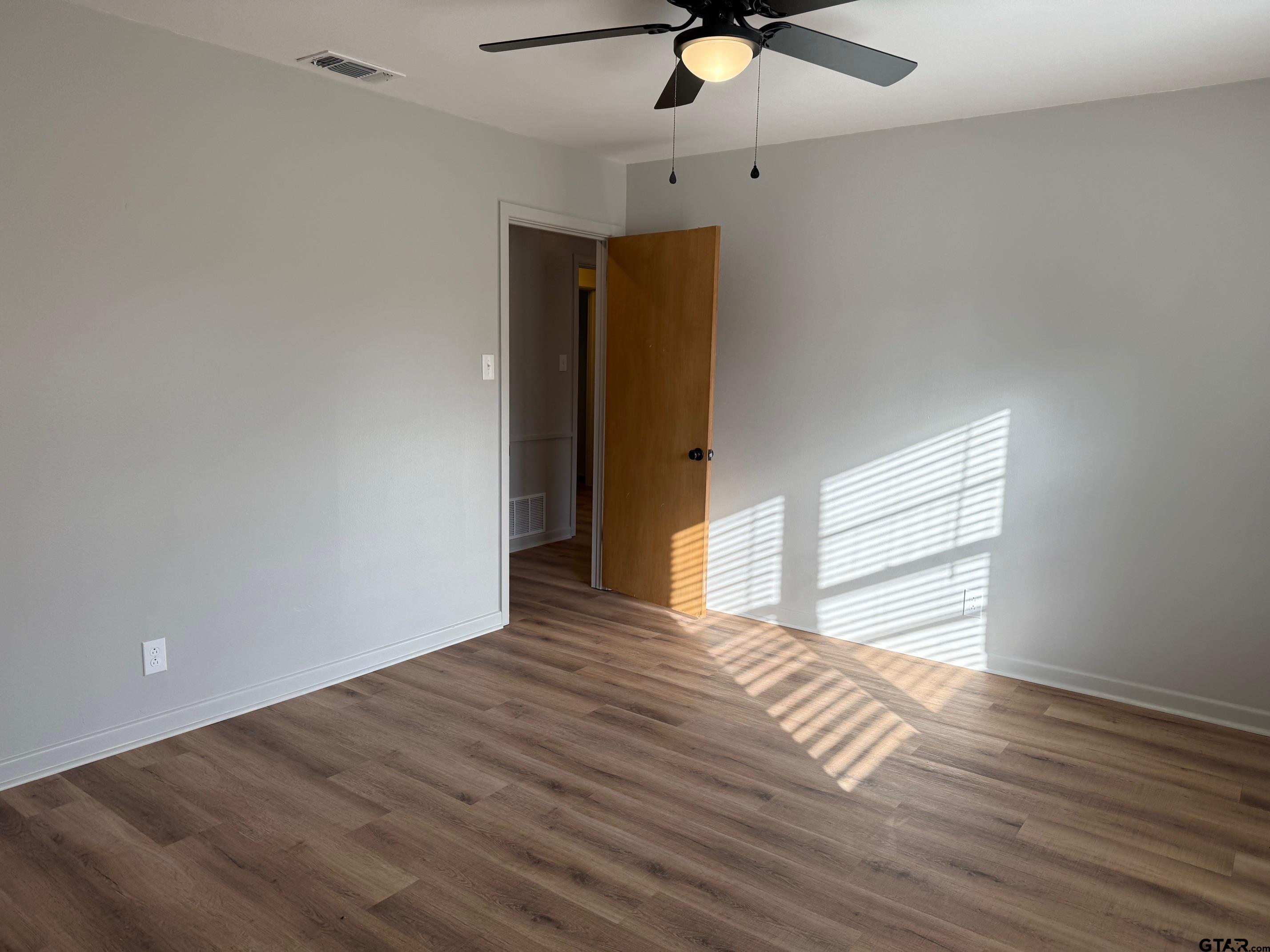 301 Ridgecrest Drive Tyler, TX 75701 - Photo 18 of 27 a view of empty room with wooden floor