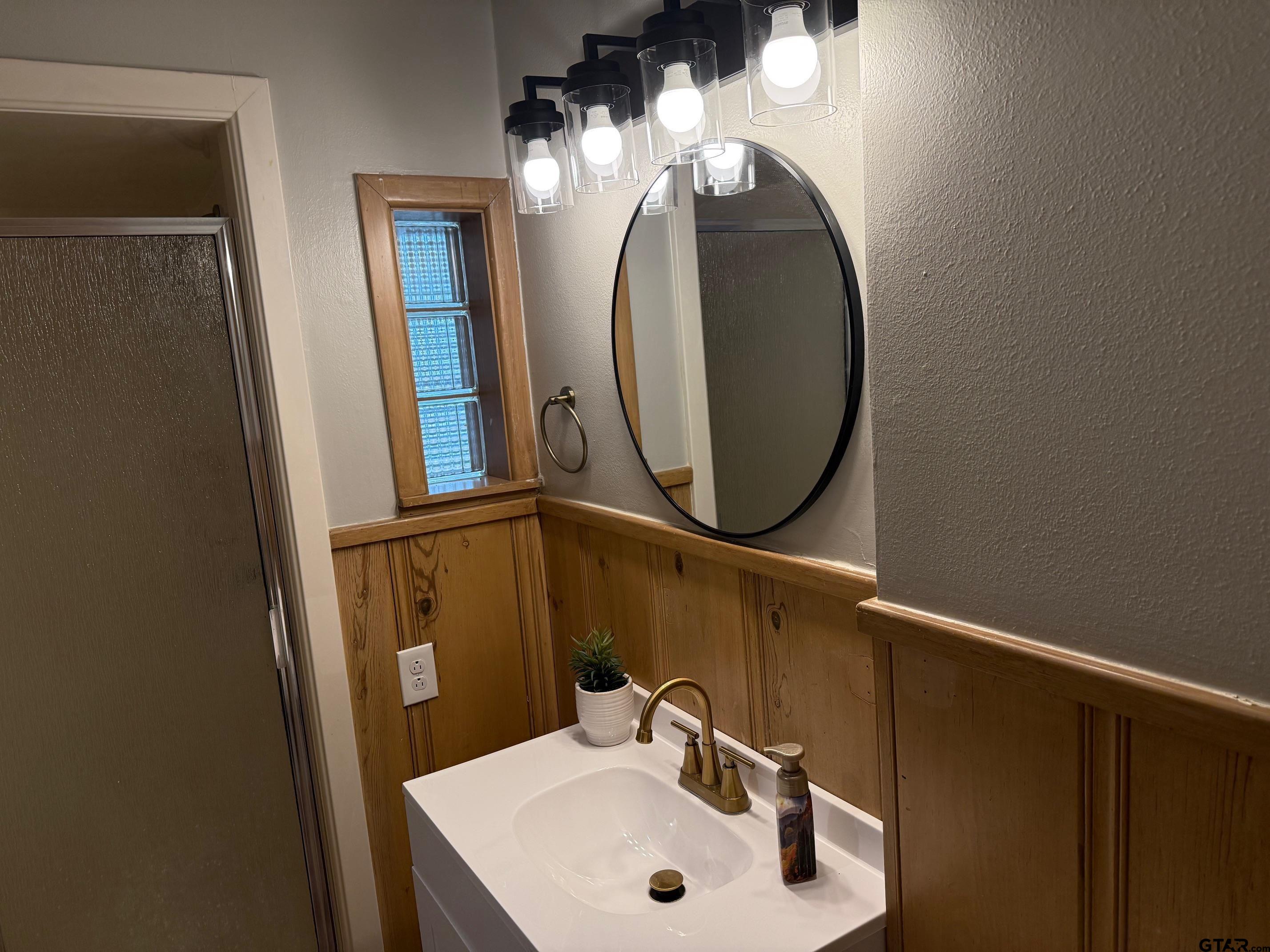 301 Ridgecrest Drive Tyler, TX 75701 - Photo 21 of 27 a bathroom with a sink and a mirror