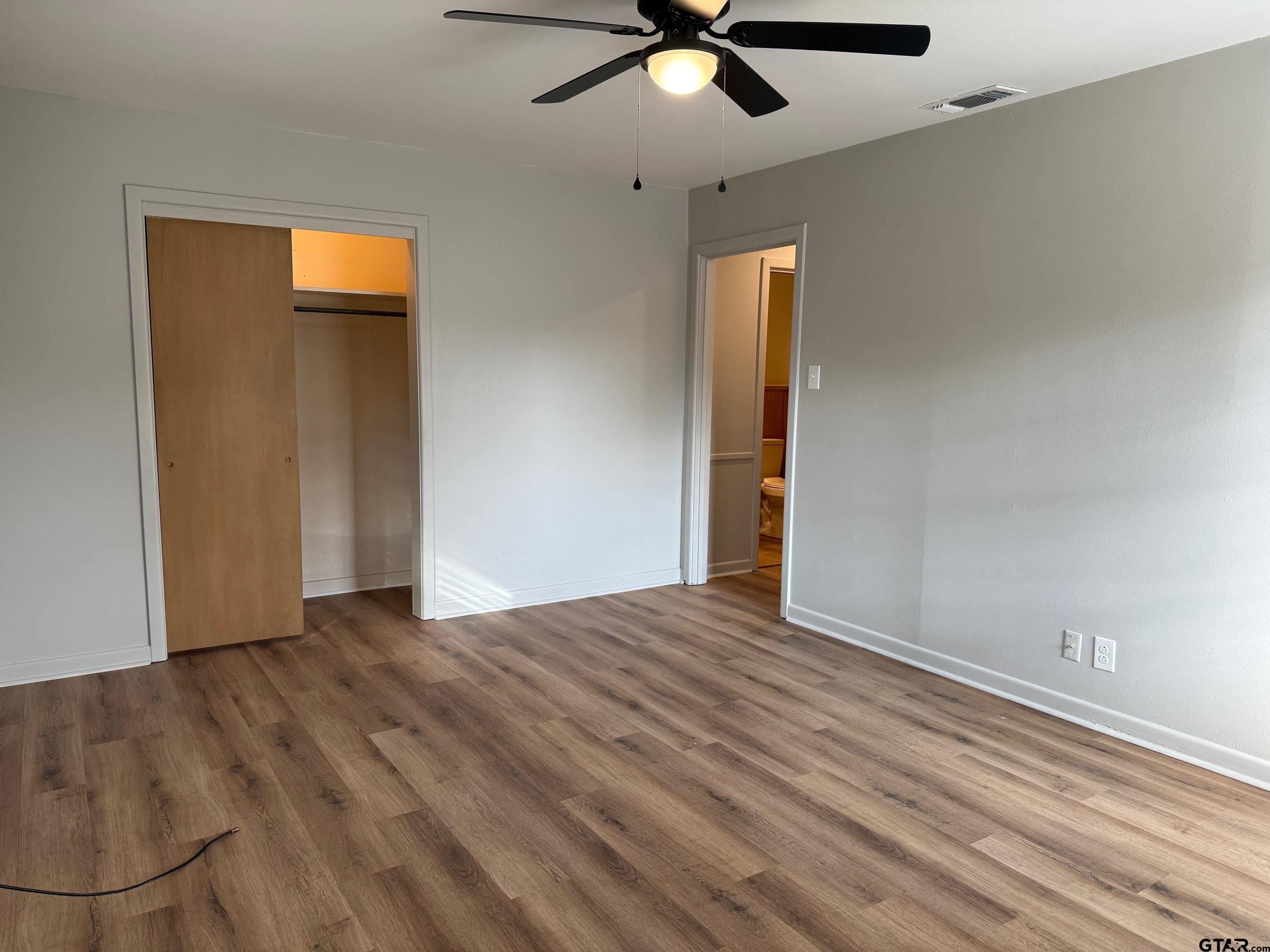 301 Ridgecrest Drive Tyler, TX 75701 - Photo 23 of 27 a view of an empty room with wooden floor and a window