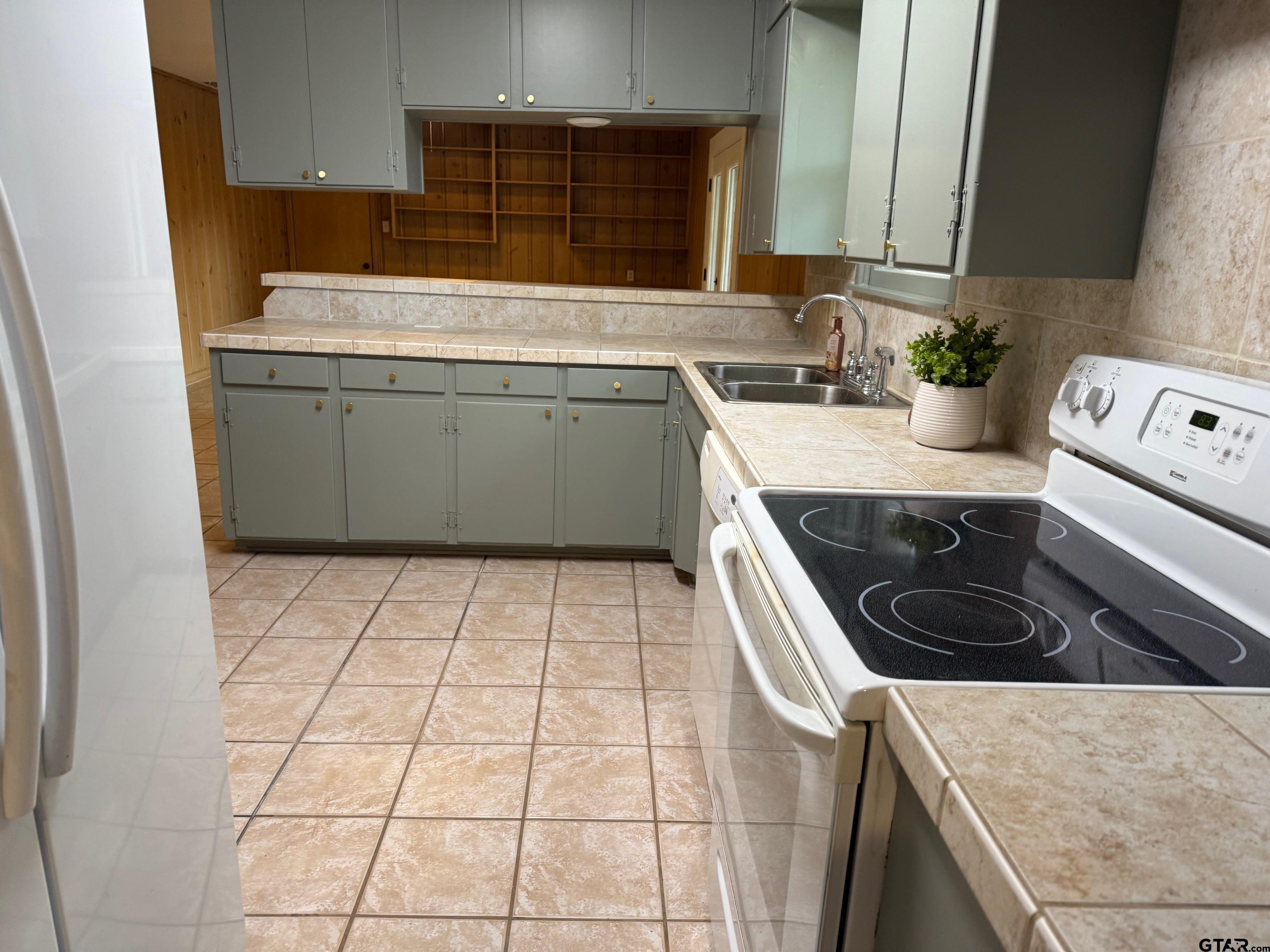 301 Ridgecrest Drive Tyler, TX 75701 - Photo 4 of 27 a kitchen with a sink a stove top oven and cabinets