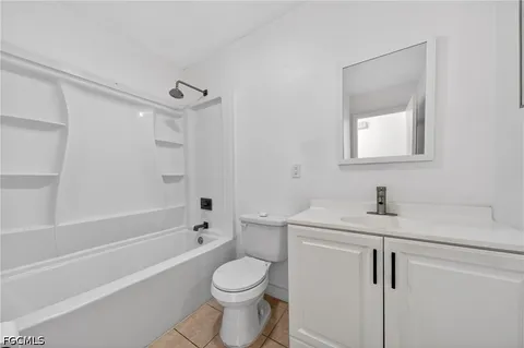 a bathroom with a granite countertop sink a toilet and shower