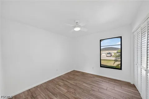 wooden floor in an empty room with a window