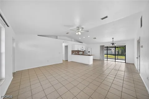 a view of an empty room with window and cabinet