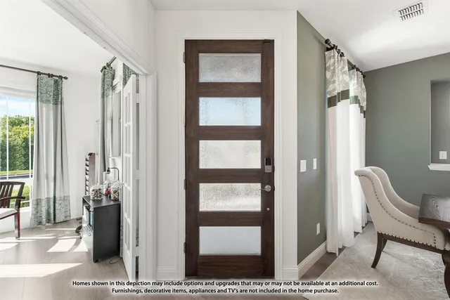 a view of a hallway with wooden floor and windows