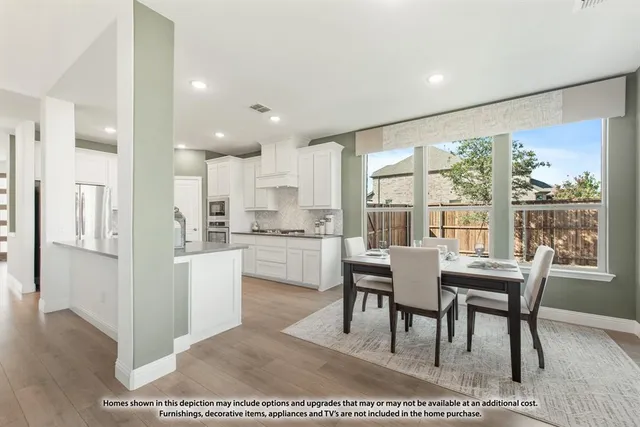 a dining room with furniture and a large window