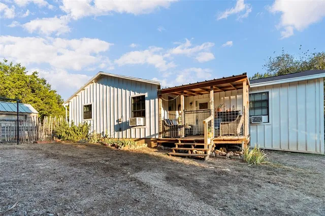 a view of a house with backyard and sitting area