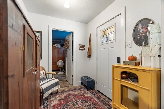 a living room with fireplace furniture and a floor to ceiling window