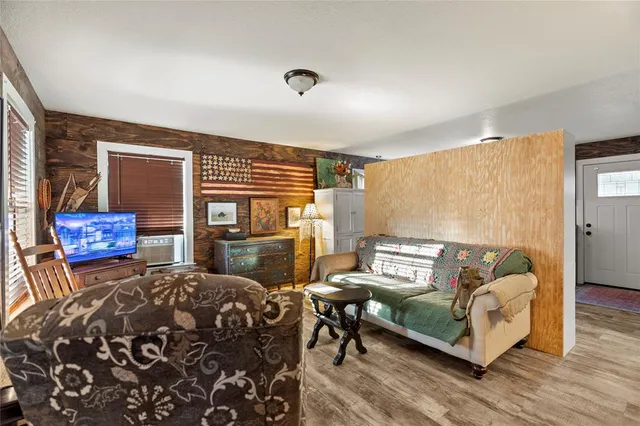a kitchen with stainless steel appliances granite countertop a table chairs and a refrigerator