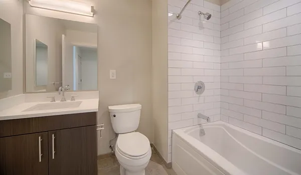 a bathroom with a sink a toilet and bathtub