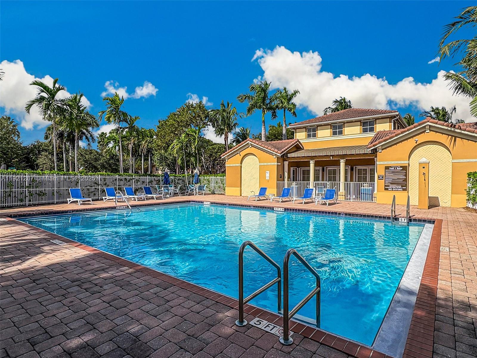 12230 Southwest 123rd Pass Miami, FL 33186 - Photo 11 of 65 a view of a swimming pool with a lounge chairs