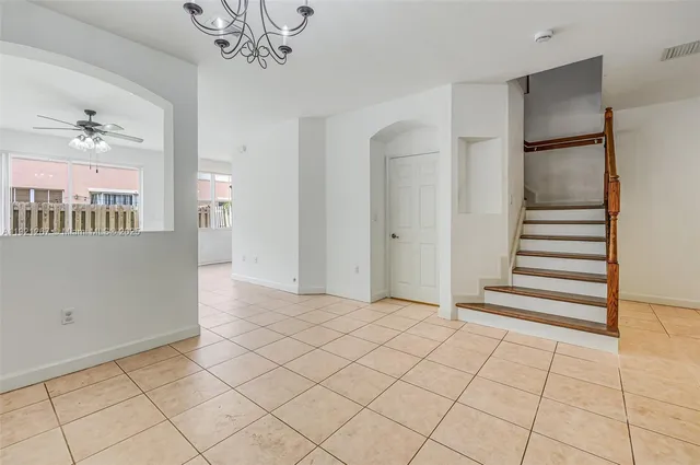 a view of a hallway with wooden floor and stairs