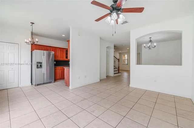 a view of a livingroom with wooden floor and a ceiling fan