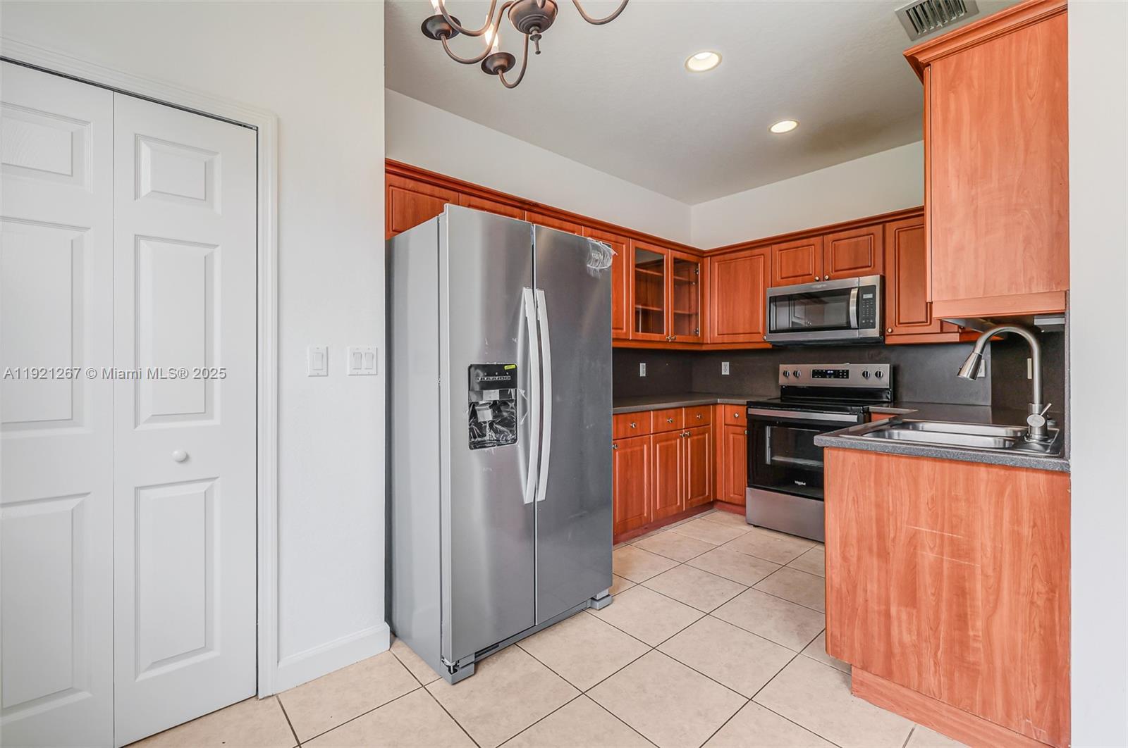 12230 Southwest 123rd Pass Miami, FL 33186 - Photo 36 of 64 a kitchen with stainless steel appliances granite countertop a refrigerator and a stove top oven