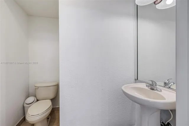 an empty room with a window and wooden floor