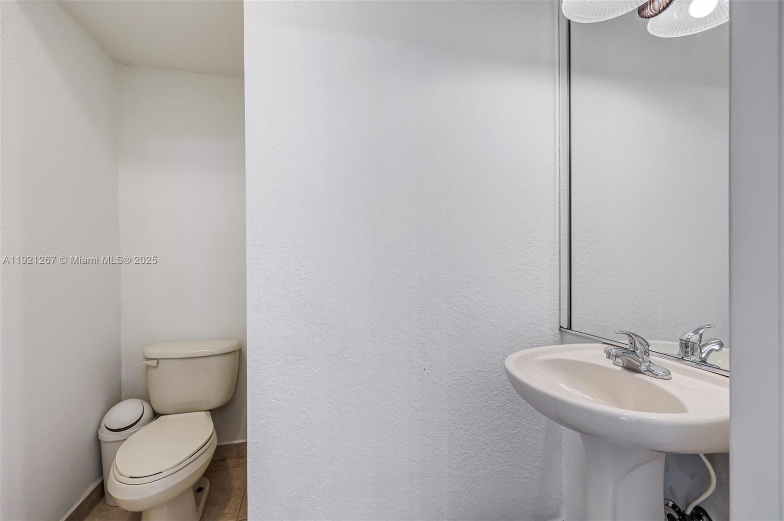 12230 Southwest 123rd Pass Miami, FL 33186 - Photo 40 of 64 a bathroom with a toilet sink and mirror