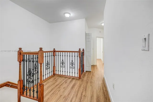 a view of a room with wooden floor