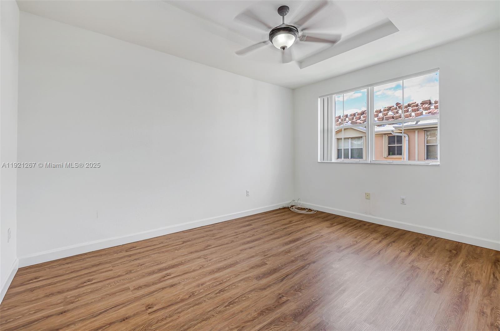 12230 Southwest 123rd Pass Miami, FL 33186 - Photo 42 of 64 wooden floor in an empty room with a window