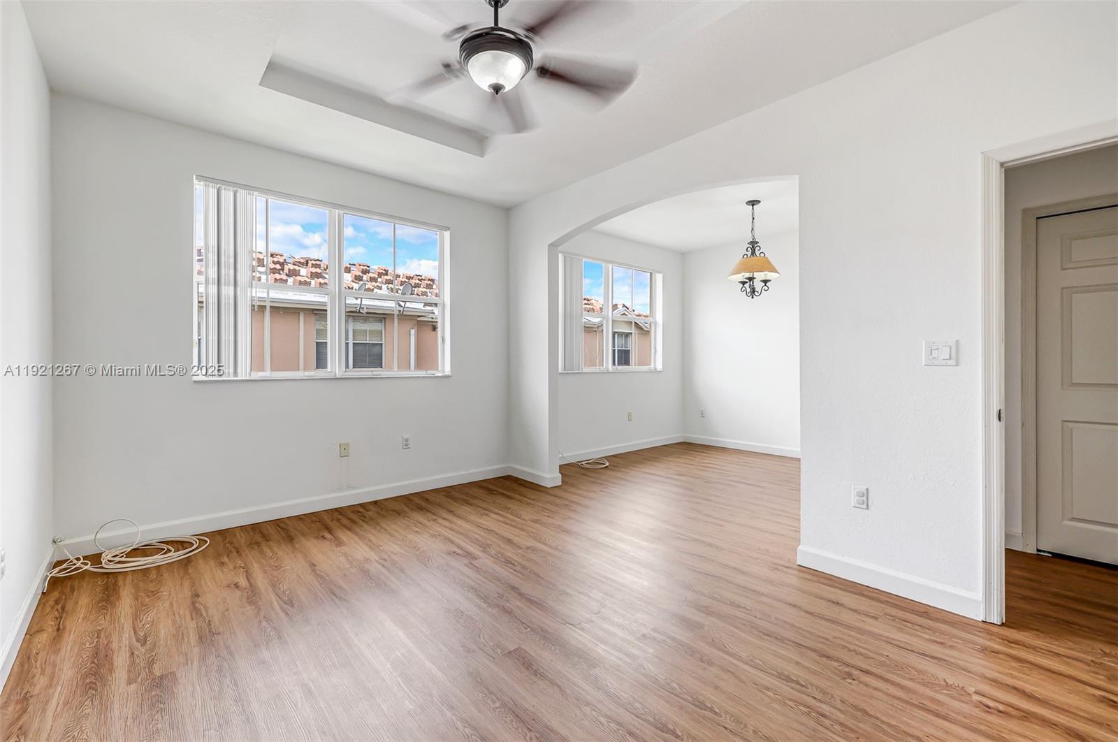 12230 Southwest 123rd Pass Miami, FL 33186 - Photo 43 of 64 a view of an empty room with wooden floor and a window